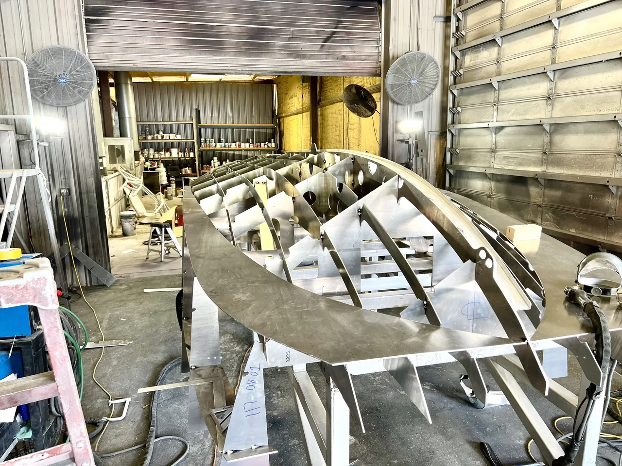 The internal framing of an unfinished boat hull in the Armory