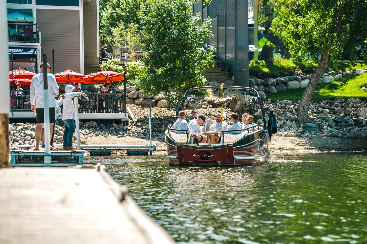 An Anthem boat carrying a group beside a waterfront dock