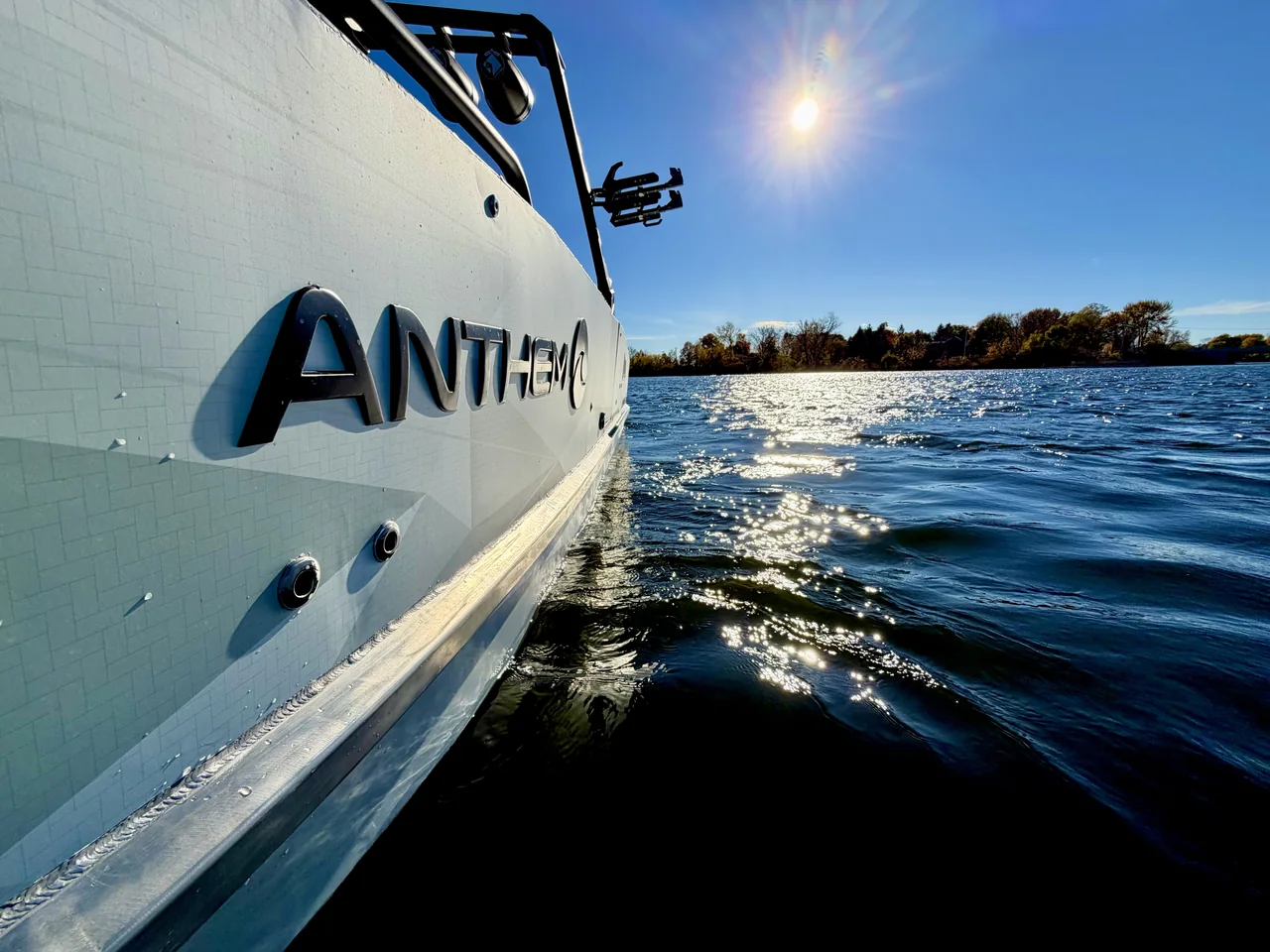 Anthem lettering on a white hull beside the water