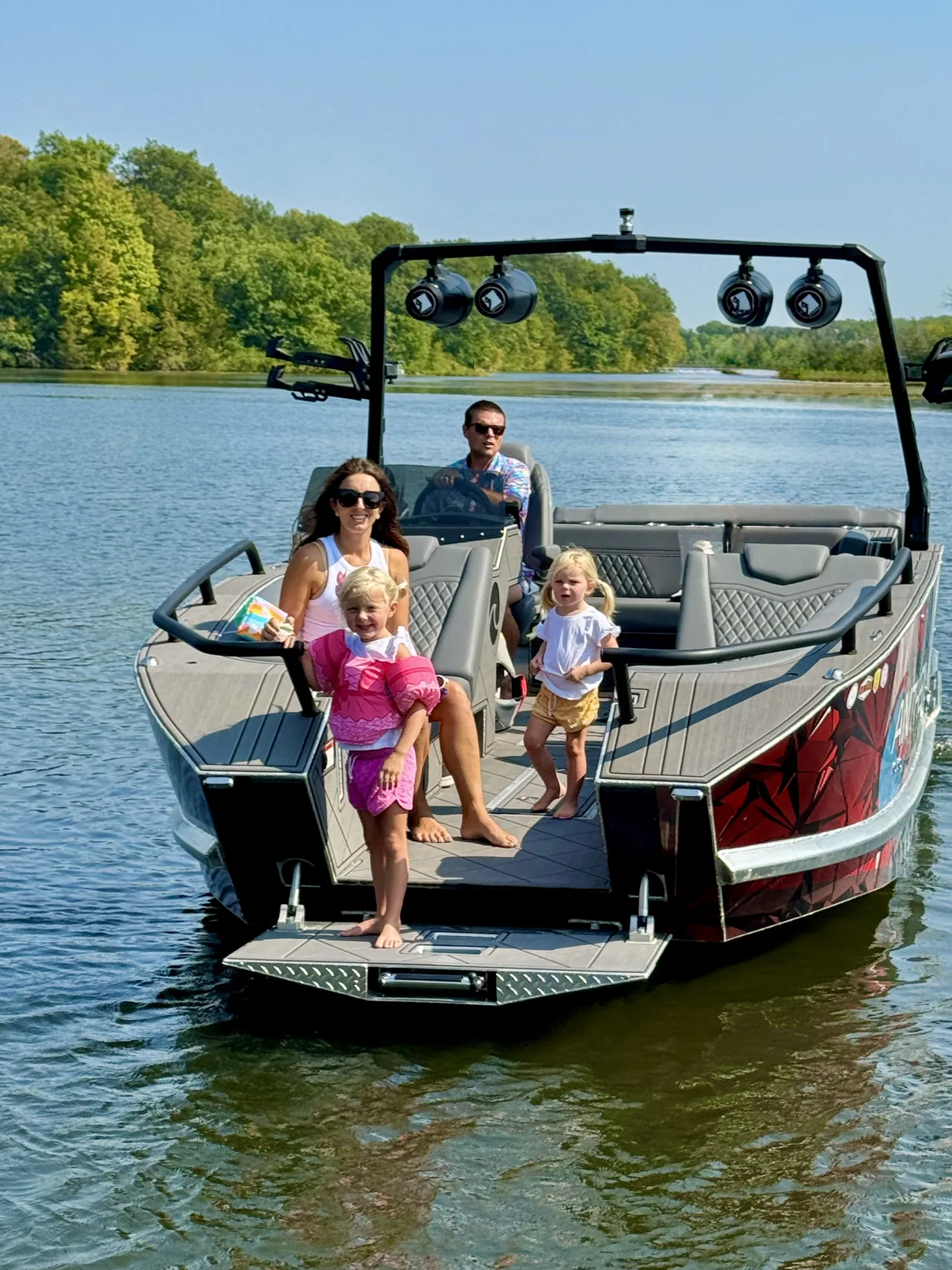 A family at the Anthem bow ramp in shallow water