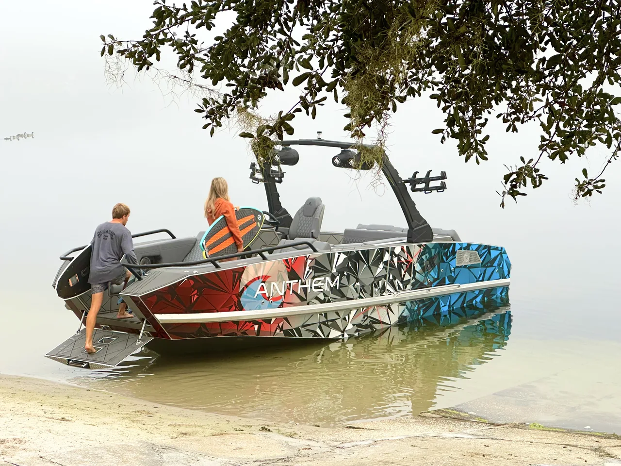 Guests walking between an Anthem boat and the beach through the bow ramp