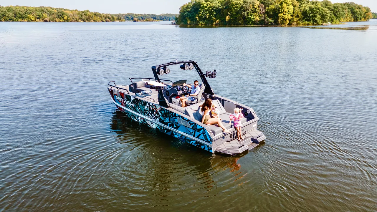People gathering aboard the Assault XR23 near shore